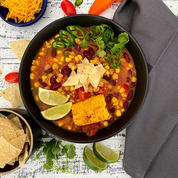 Tortilla Soup: Simple, hearty from south of the border vegetable soup explodes with healthy flavor. Tomatoes, corn, onions, peppers, and beans simmered in vegetable broth with Southwestern spices, topped with tortilla chips is the ultimate bowl of comfort food.