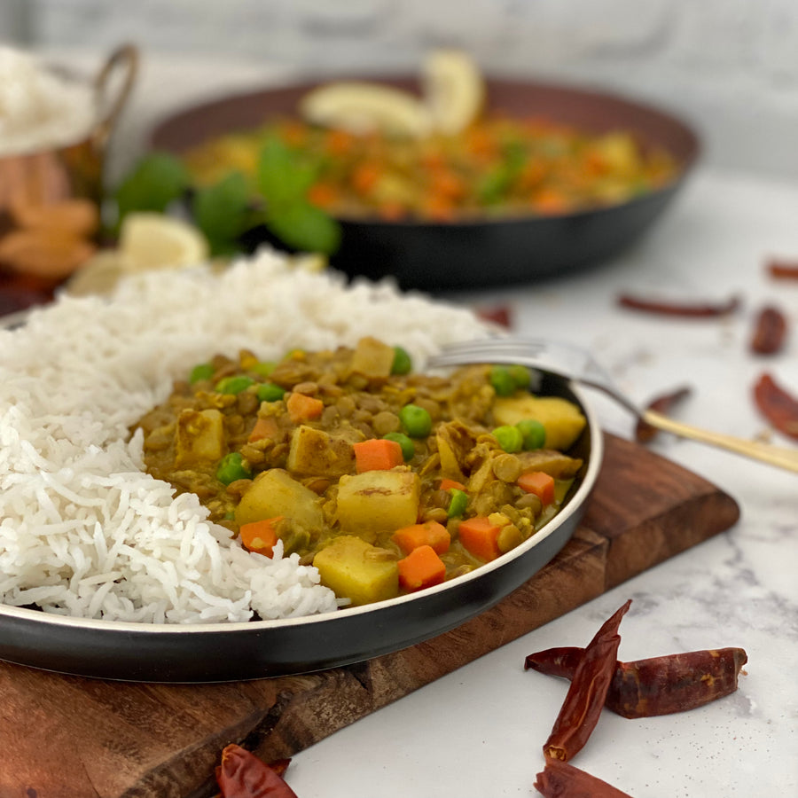 Burmese Lentil Potato Curry:  Colorful warmly spiced aromatic bowl of goodness with. Carrots, potatoes, lentils, and peas simmered in luxuriously rich coconut milk curry sauce served over bowl of hot basmati rice.