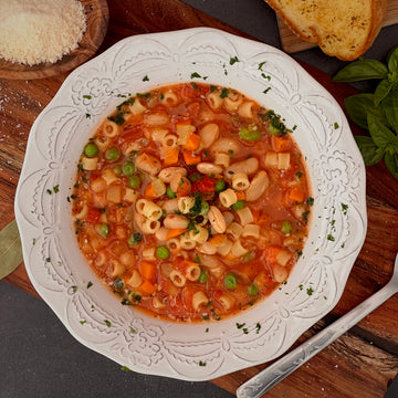 Summer Pasta e Fagioli: Classic Italian-American soup lightened up with healthy vegetables explodes with healthy flavor. Tomatoes, garlic, onions, carrots, peas, cannellini beans and pasta simmered in vegetable broth is the ultimate bowl of comfort food.